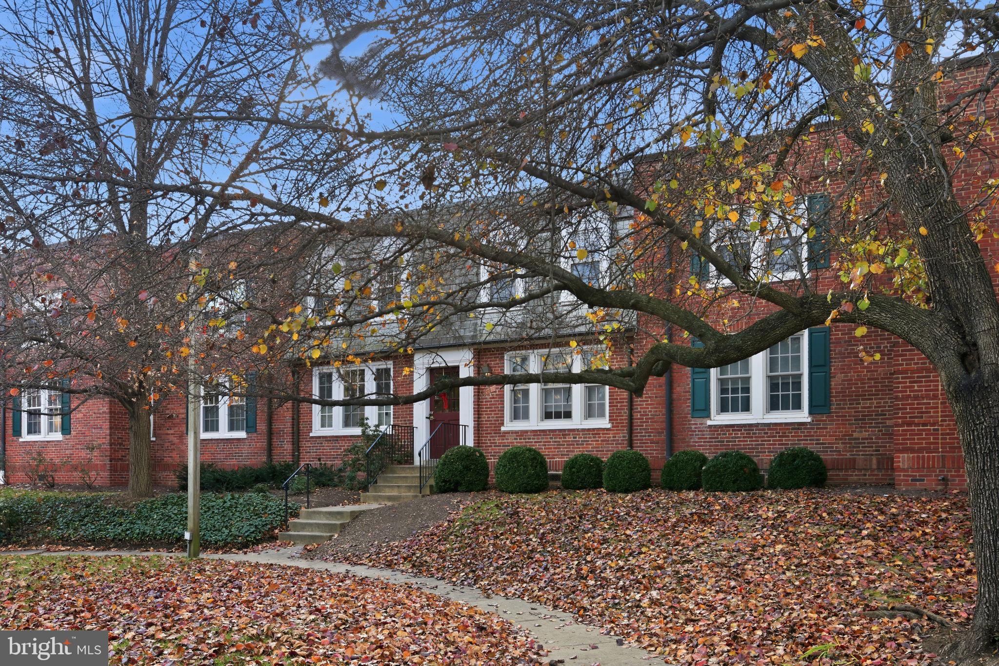 1744 North Rhodes Street, Unit 310 Arlington, VA 22201 - Photo 2 of 24 a view of a brick building next to a yard