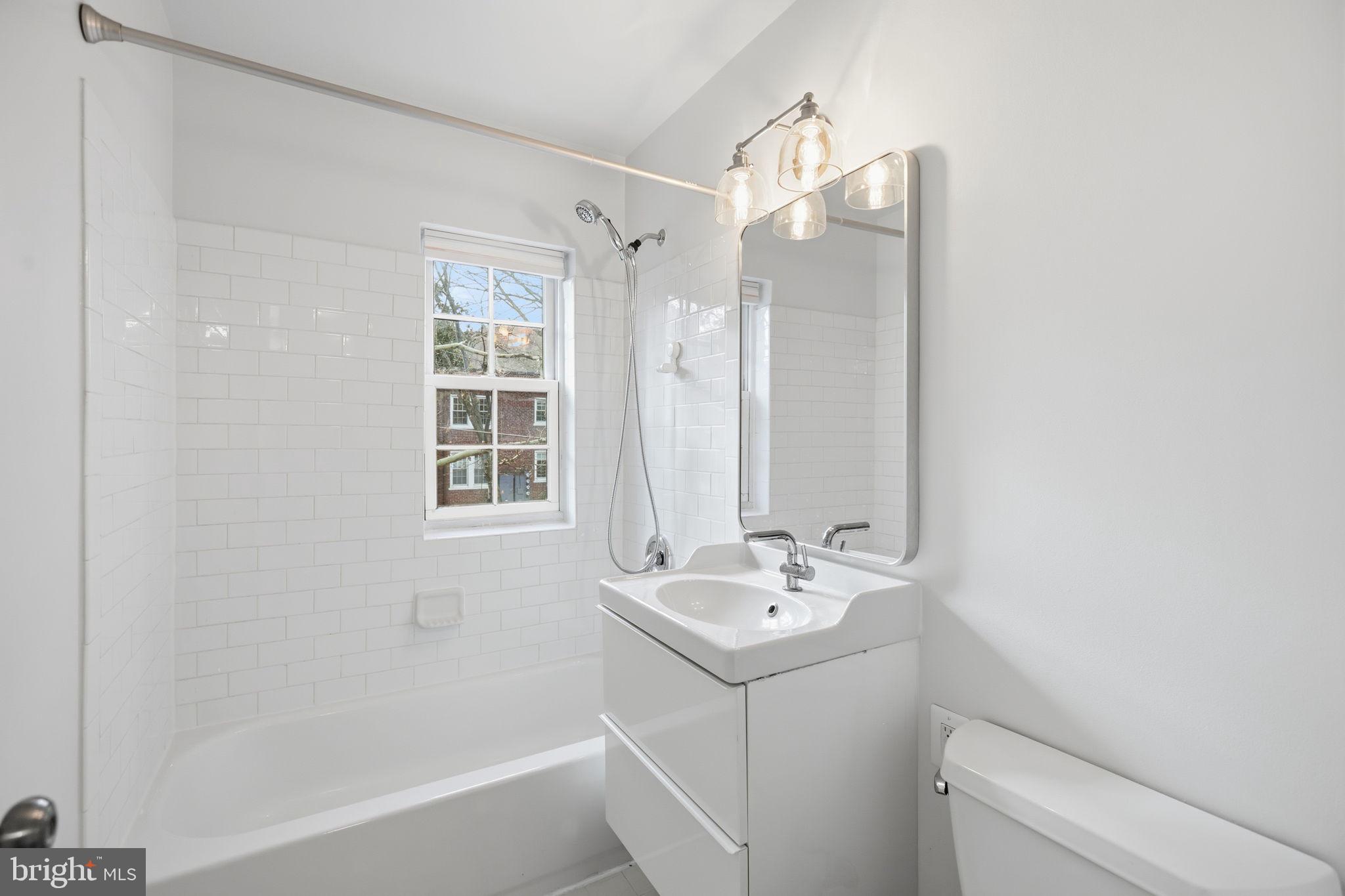 1744 North Rhodes Street, Unit 310 Arlington, VA 22201 - Photo 23 of 24 a bathroom with a sink a toilet and shower