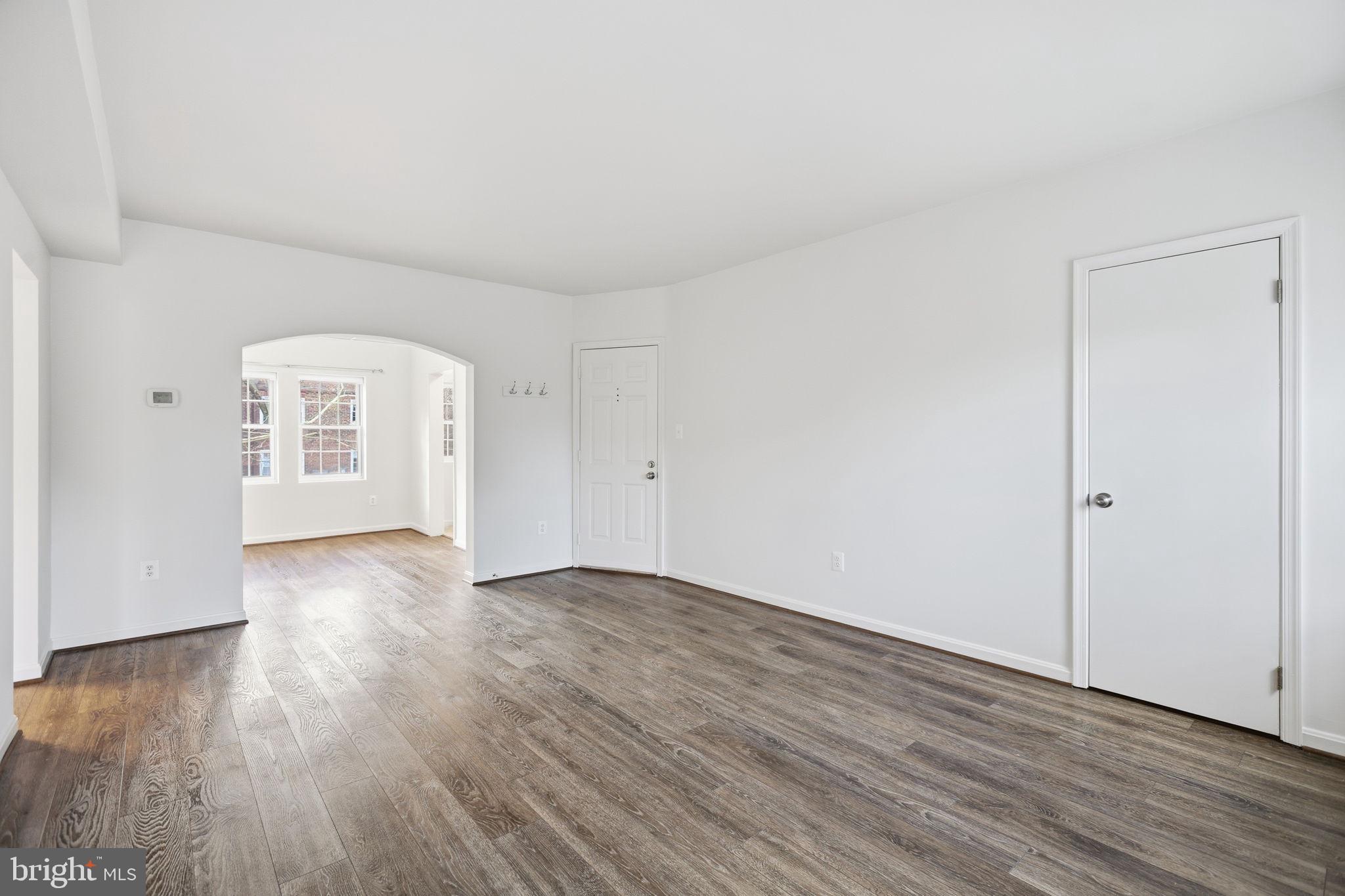 1744 North Rhodes Street, Unit 310 Arlington, VA 22201 - Photo 5 of 24 a view of an empty room with wooden floor and a window