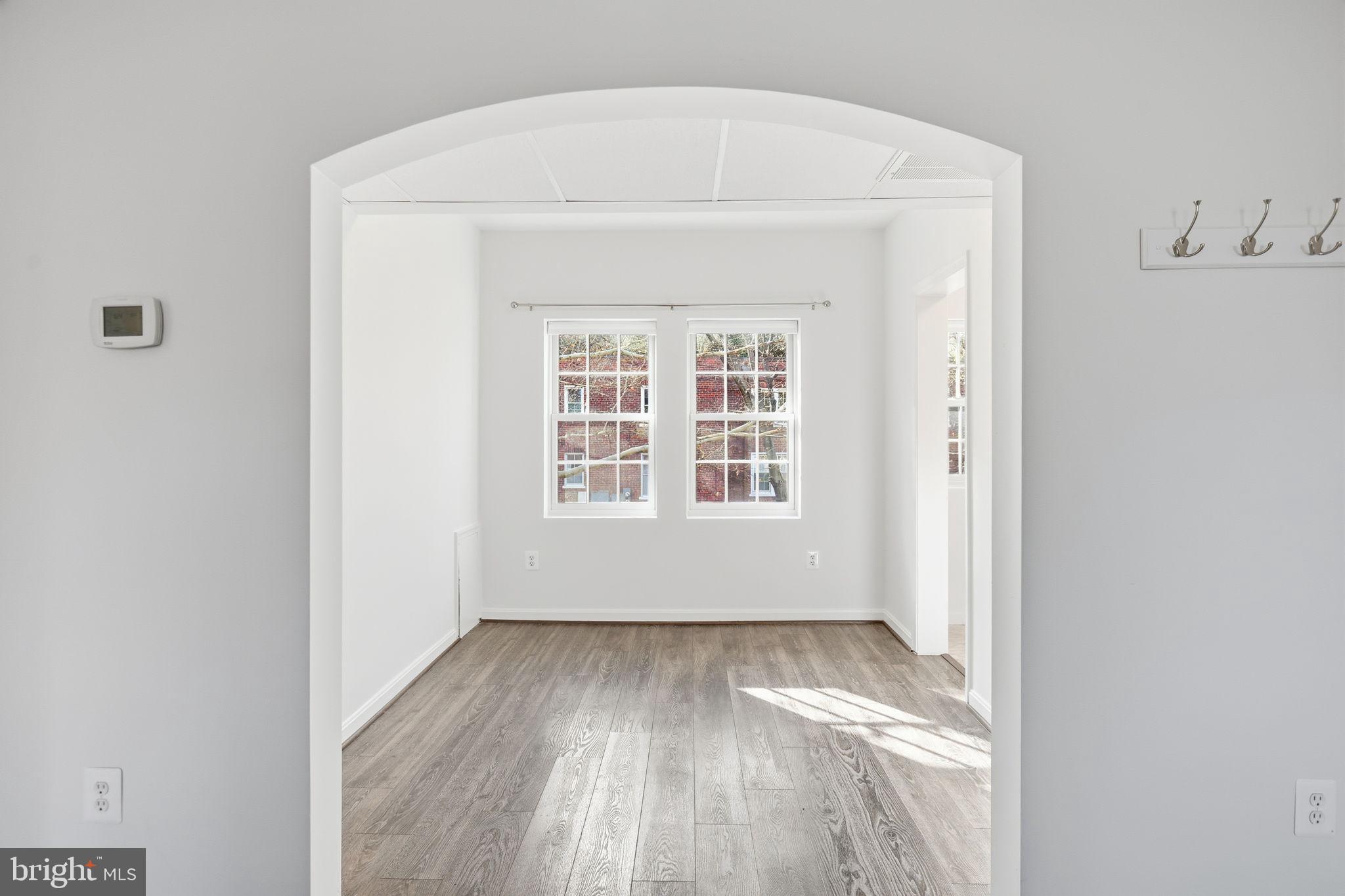 1744 North Rhodes Street, Unit 310 Arlington, VA 22201 - Photo 6 of 24 a view of wooden floor in a room