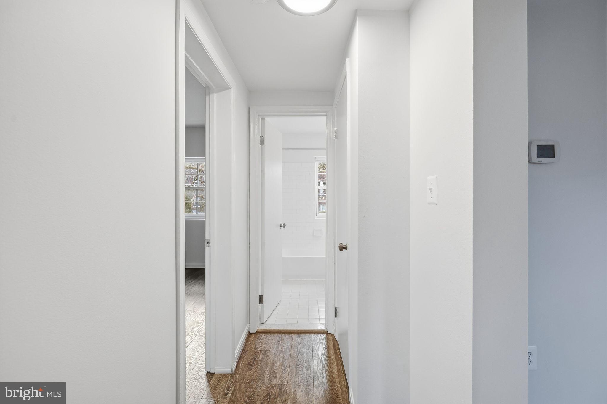 1744 North Rhodes Street, Unit 310 Arlington, VA 22201 - Photo 7 of 24 a view of a hallway with wooden floor