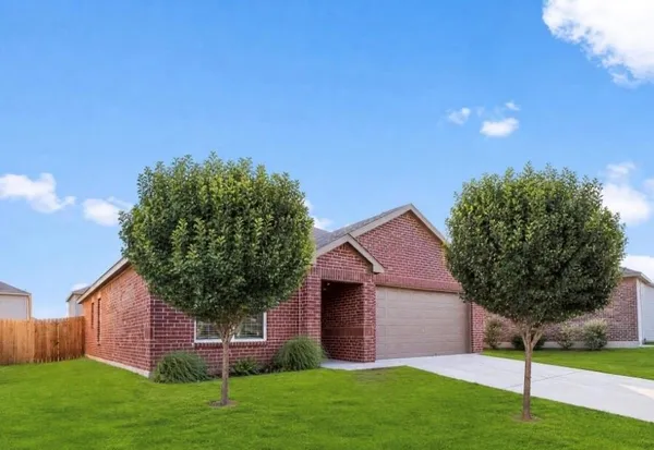 a house with green field in front of it