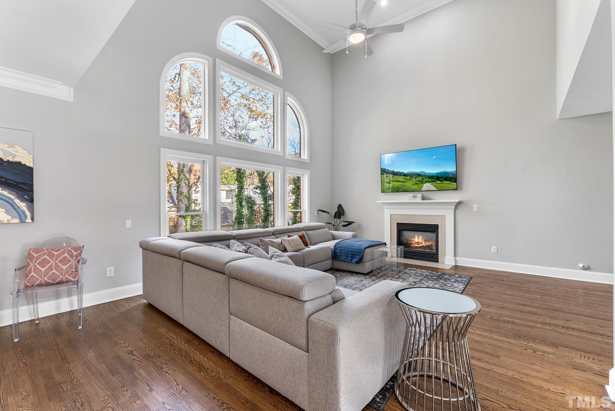 111 Redfern Drive Cary, NC 27518 - Photo 12 of 65 a living room with furniture a fireplace and a flat screen tv