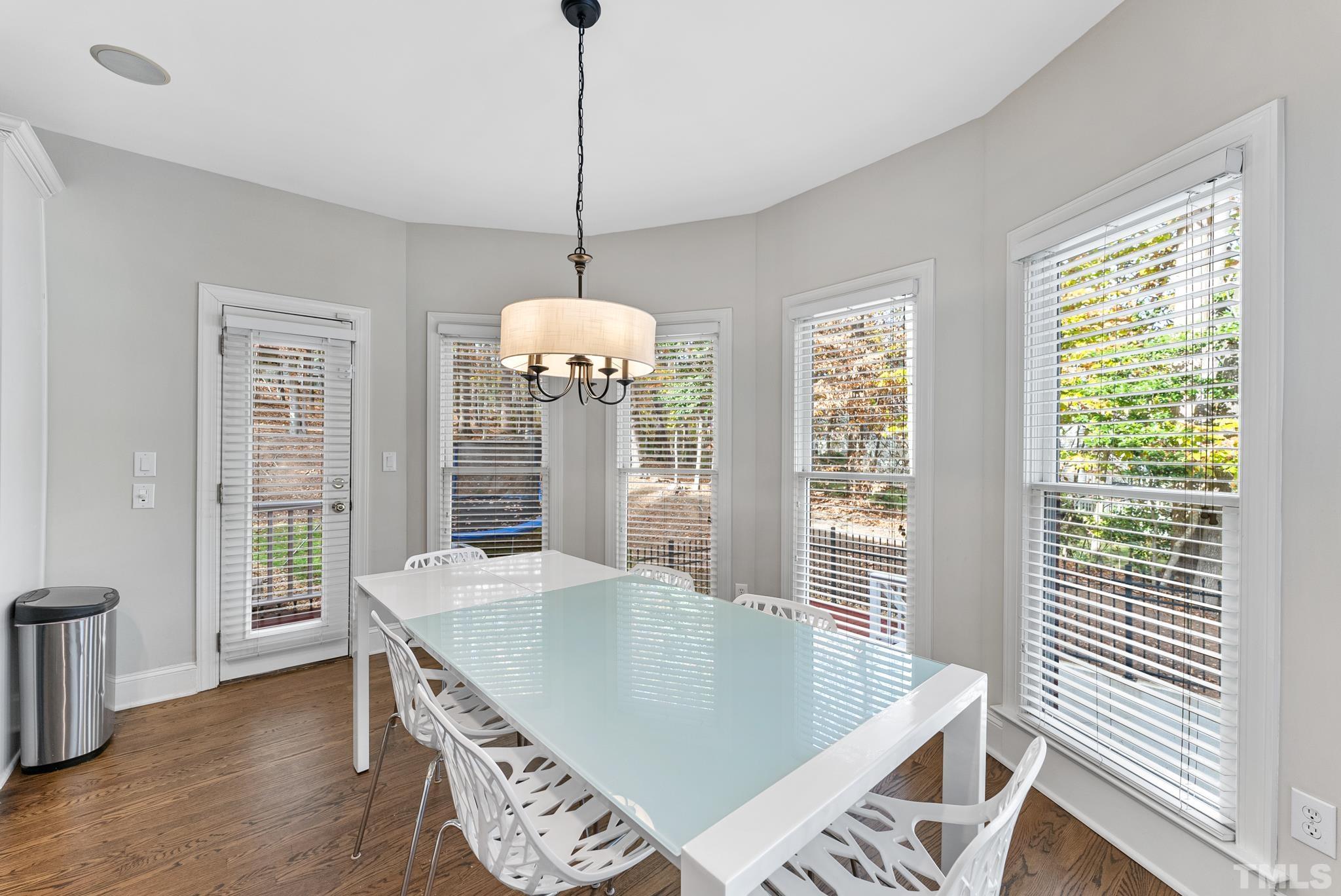 111 Redfern Drive Cary, NC 27518 - Photo 21 of 65 a view of a dining room with furniture wooden floor and chandelier