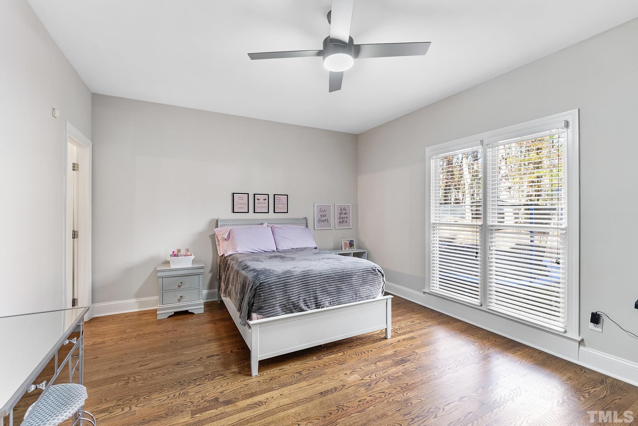 111 Redfern Drive Cary, NC 27518 - Photo 22 of 65 a bedroom with a bed and a large window