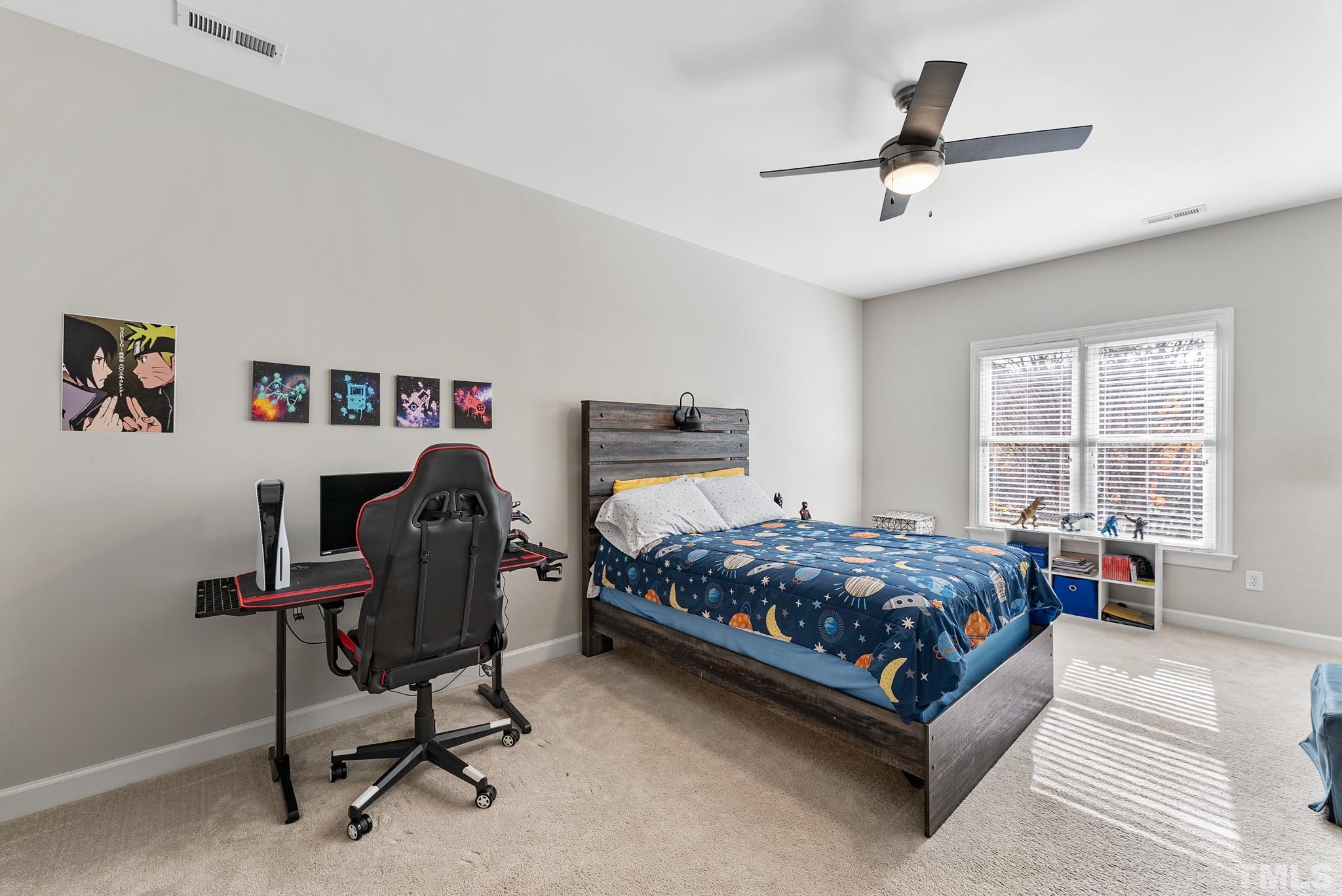 111 Redfern Drive Cary, NC 27518 - Photo 29 of 65 a bedroom with a bed a desk and chair with window