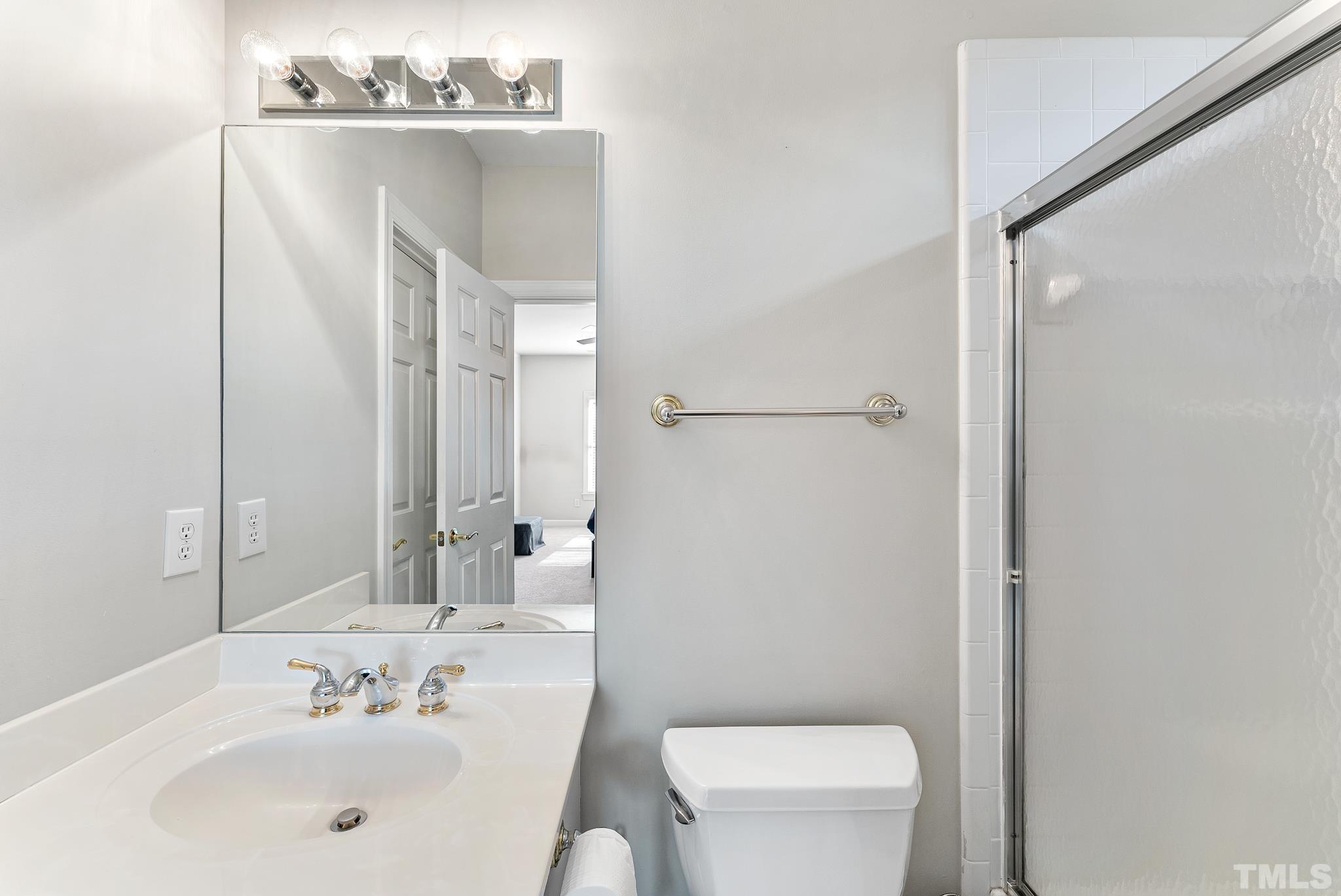 111 Redfern Drive Cary, NC 27518 - Photo 30 of 65 a bathroom with a sink a toilet and shower