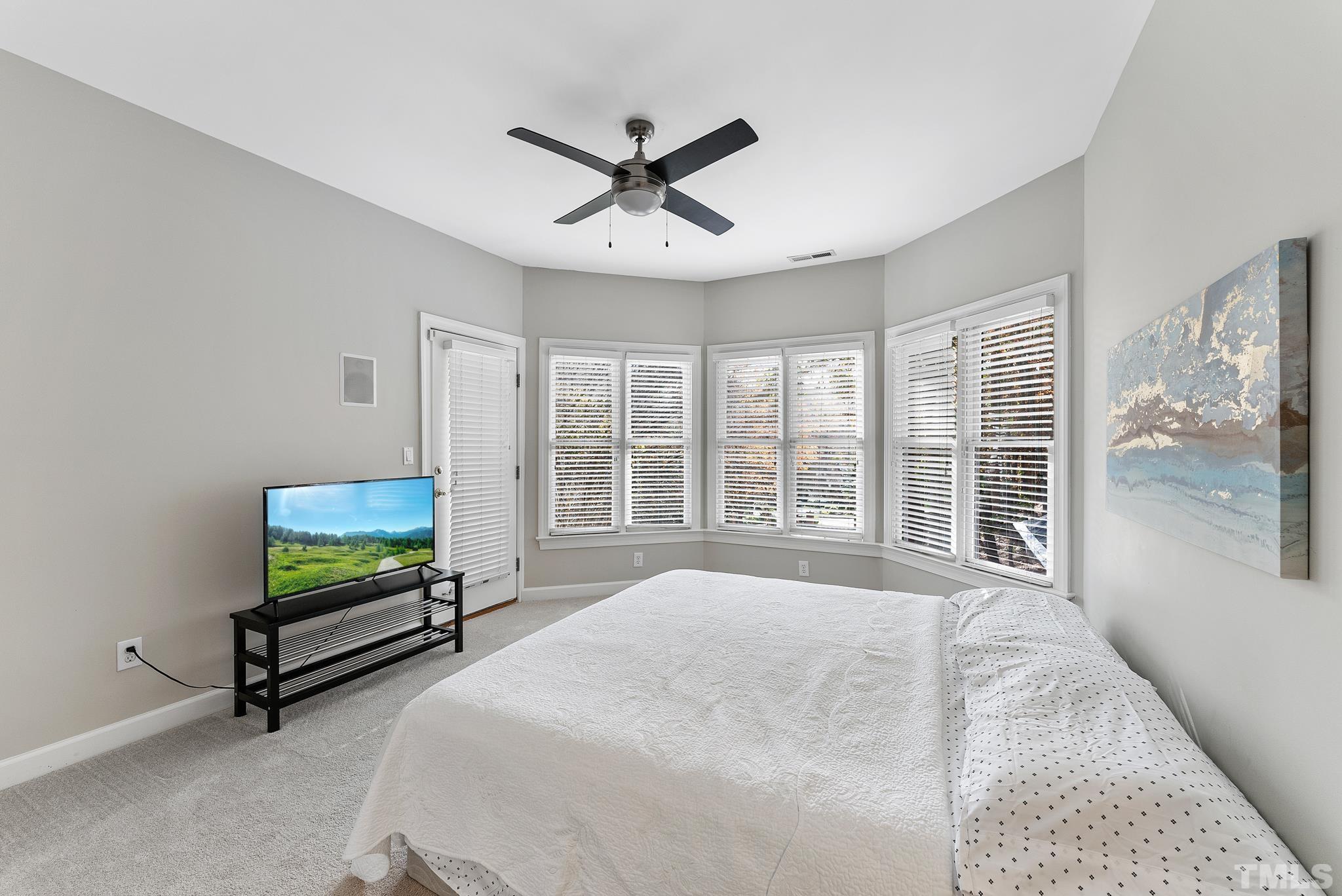 111 Redfern Drive Cary, NC 27518 - Photo 32 of 65 a bedroom with a bed and a large window