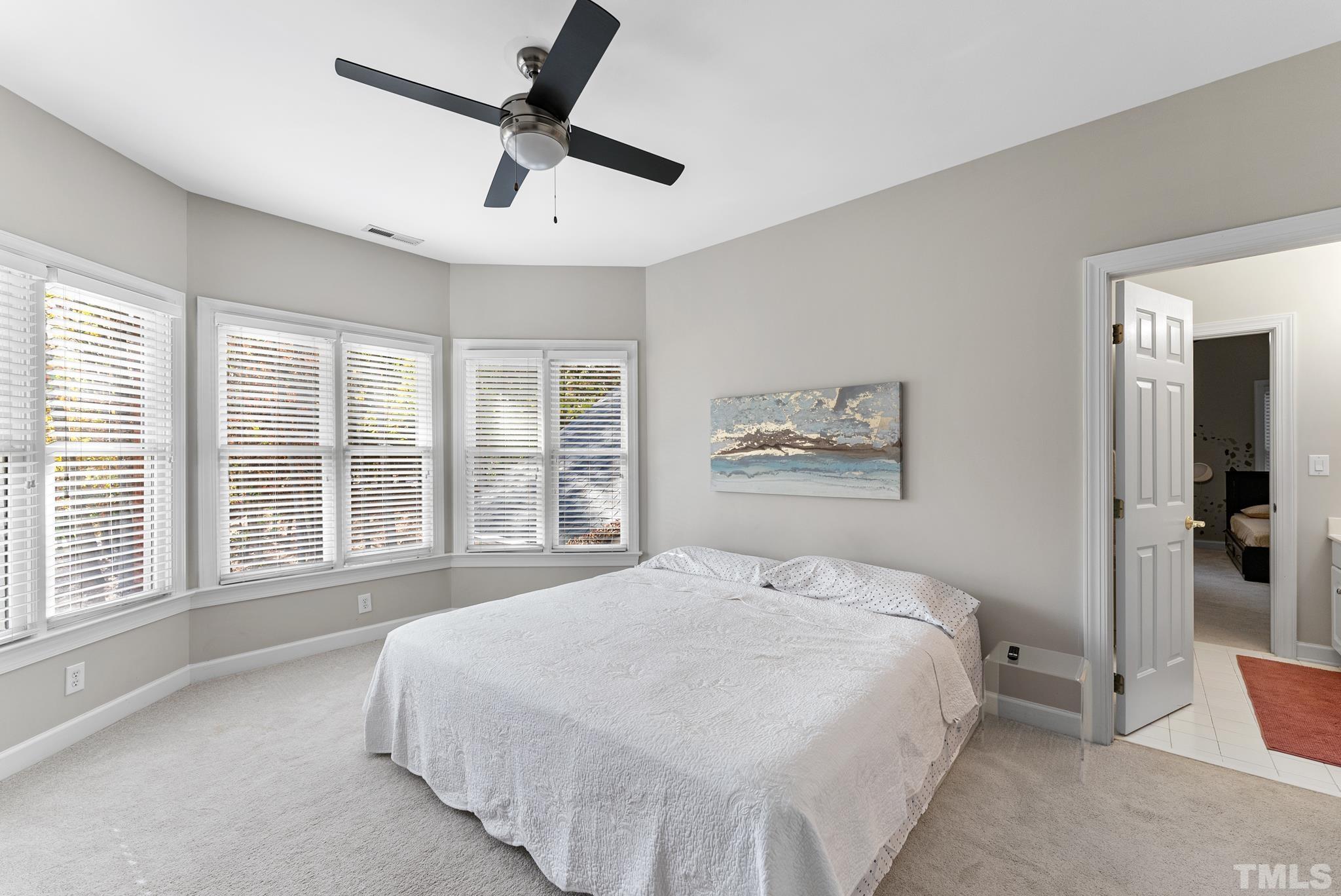 111 Redfern Drive Cary, NC 27518 - Photo 33 of 65 a bedroom with a large bed and a large window