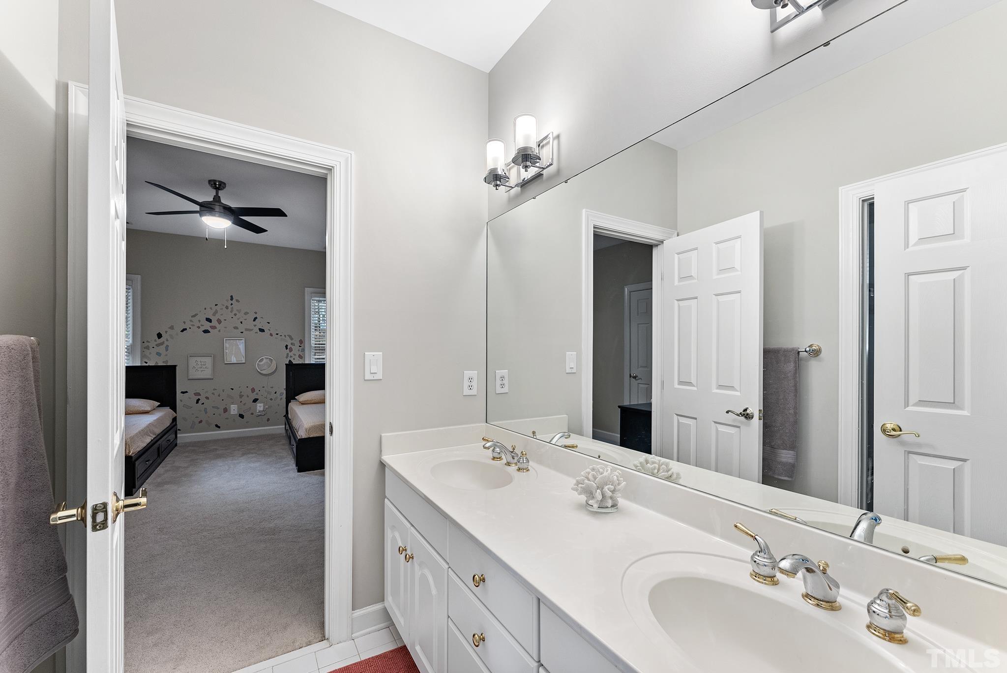 111 Redfern Drive Cary, NC 27518 - Photo 35 of 65 a spacious bathroom with a double vanity sink a mirror and a shower