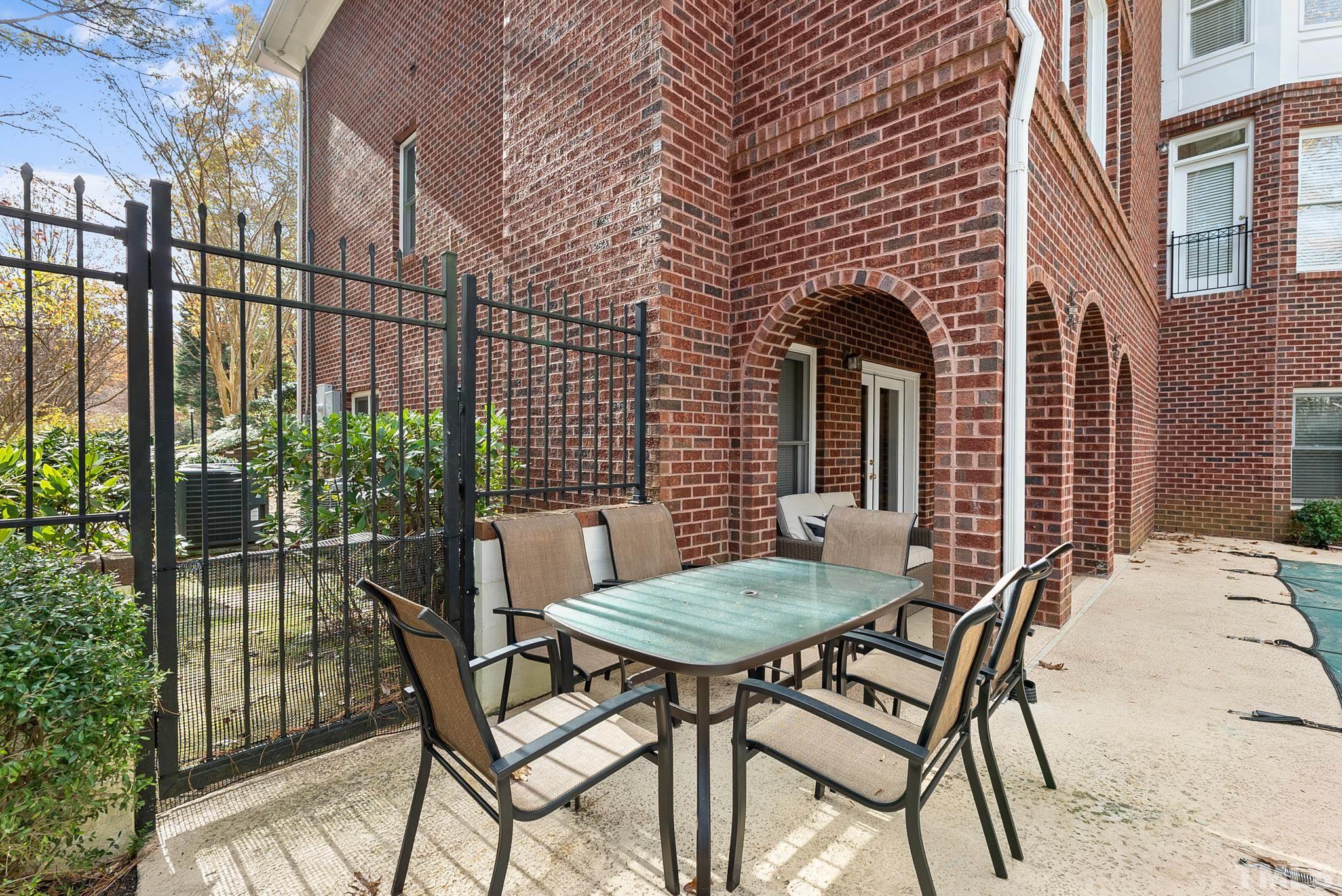 111 Redfern Drive Cary, NC 27518 - Photo 53 of 65 a view of a patio with table and chairs with wooden floor and plants