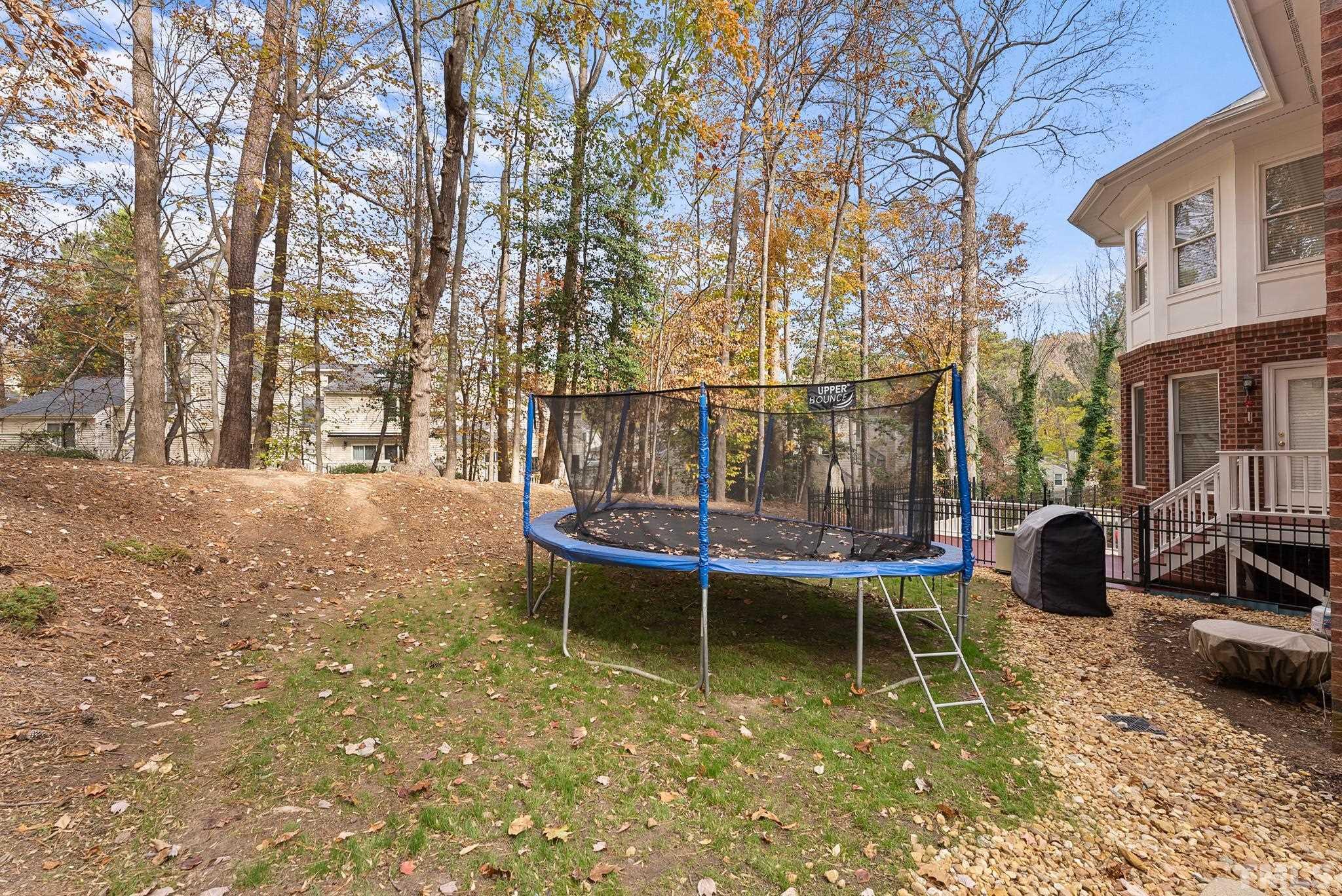 111 Redfern Drive Cary, NC 27518 - Photo 60 of 65 a view of a swimming pool with a patio and backyard