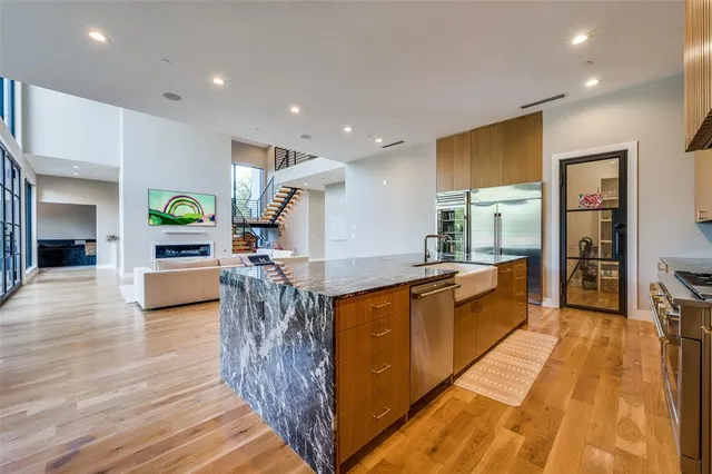 a large kitchen with stainless steel appliances granite countertop a large counter top and a stove