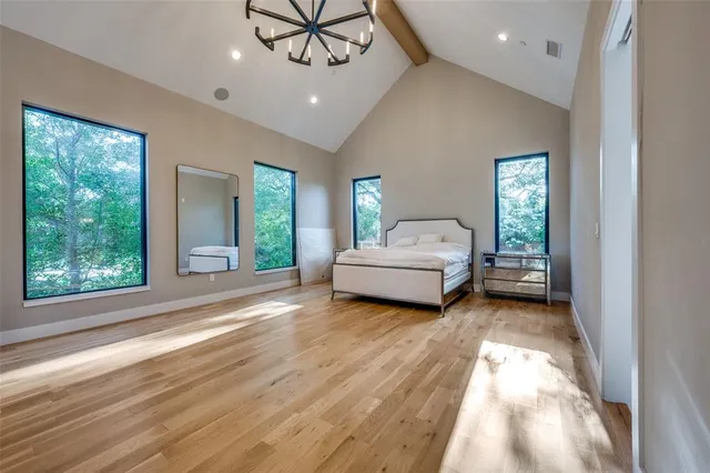 a view of a bedroom with a bed and a window