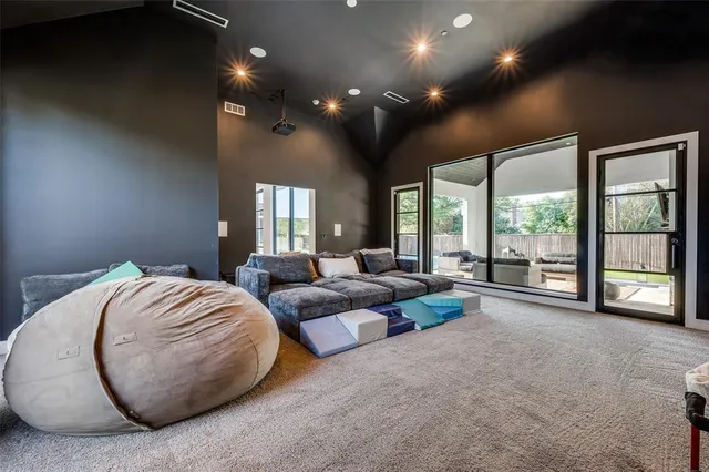 a spacious bedroom with large windows and a bed