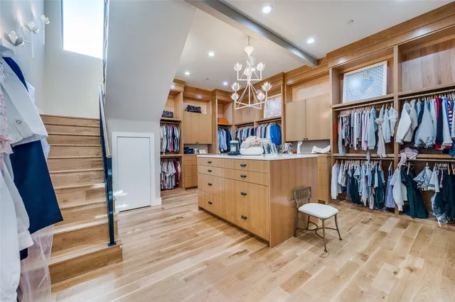 a room with lots of wooden furniture and a book shelf