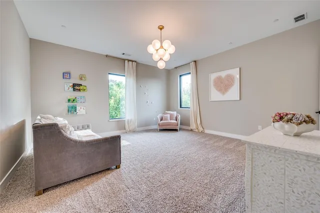 a living room with furniture and a chandelier