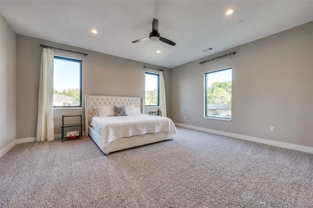 a spacious bedroom with a bed and a window