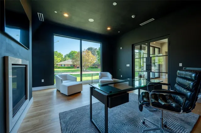 a living room with furniture and a floor to ceiling window