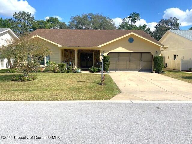 2671 Royal Ridge Drive Spring Hill, FL 34606 - Photo 1 of 34 a front view of house with yard