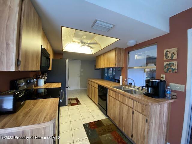 2671 Royal Ridge Drive Spring Hill, FL 34606 - Photo 13 of 34 a kitchen with stainless steel appliances granite countertop a sink stove and cabinets