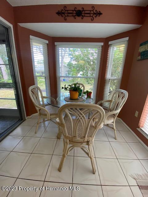 2671 Royal Ridge Drive Spring Hill, FL 34606 - Photo 14 of 34 a dining room with furniture and large windows