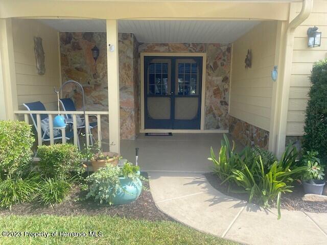 2671 Royal Ridge Drive Spring Hill, FL 34606 - Photo 2 of 34 a view of front door and potted plants