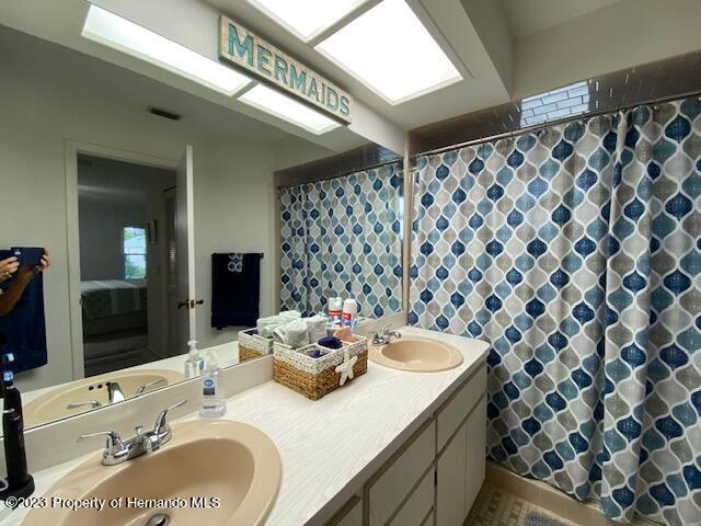 2671 Royal Ridge Drive Spring Hill, FL 34606 - Photo 21 of 34 a bathroom with a granite countertop sink and a mirror