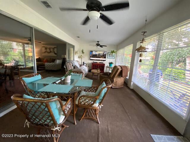 2671 Royal Ridge Drive Spring Hill, FL 34606 - Photo 23 of 34 a living room with furniture a large window and a chandelier