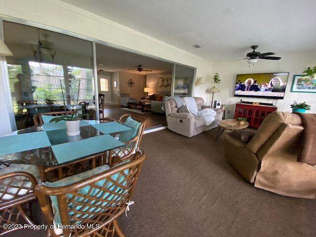 2671 Royal Ridge Drive Spring Hill, FL 34606 - Photo 24 of 34 a living room with furniture and a flat screen tv