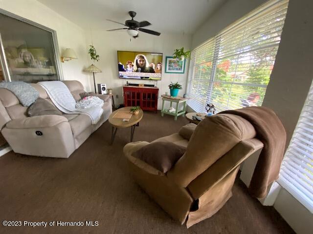 2671 Royal Ridge Drive Spring Hill, FL 34606 - Photo 25 of 34 a living room with furniture and a flat screen tv