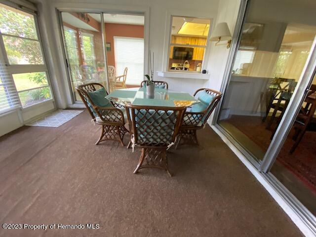 2671 Royal Ridge Drive Spring Hill, FL 34606 - Photo 27 of 34 a view of a dining room with furniture a rug and wooden floor