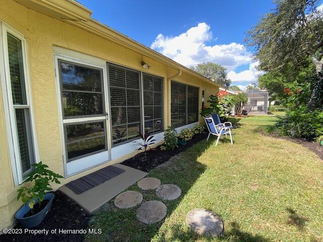 2671 Royal Ridge Drive Spring Hill, FL 34606 - Photo 30 of 34 a view of a backyard with table and chairs and potted plants
