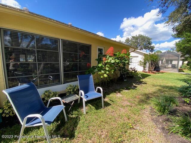 2671 Royal Ridge Drive Spring Hill, FL 34606 - Photo 32 of 34 a wooden bench sitting in front of a building