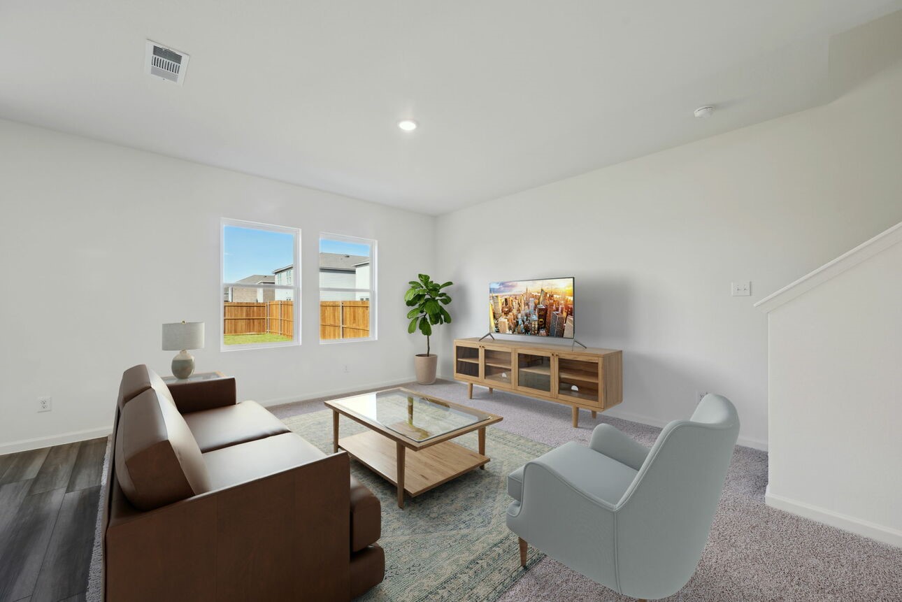 9436 Hard Rock Road Conroe, TX 77303 - Photo 5 of 12 a living room with furniture and a flat screen tv