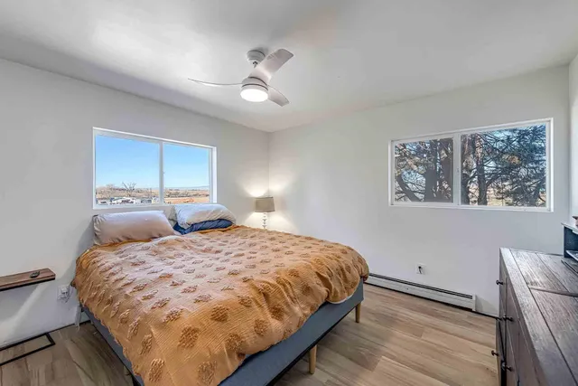 a bedroom with a bed and a painting on the wall