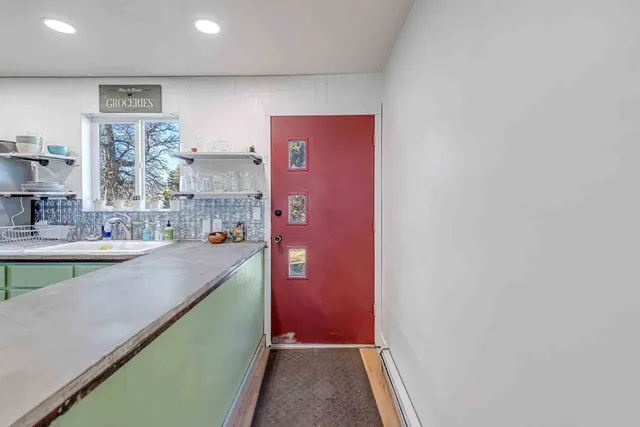 a view of a kitchen with kitchen island wooden floor and window