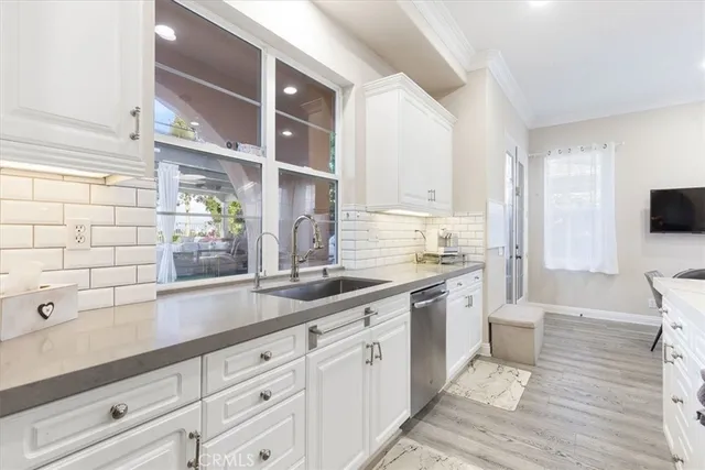 a spacious bathroom with a double vanity sink a mirror and a bathtub