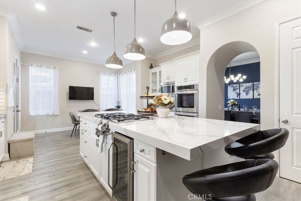 33 Craftsbury Place Ladera Ranch, CA 92694 - Photo 12 of 33 a large kitchen with kitchen island a stove a sink a dining table and chairs