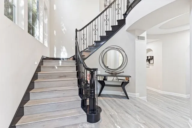 a view of entryway and hall with wooden floor