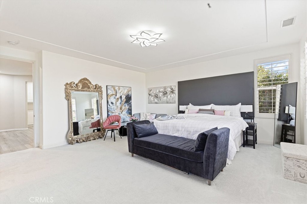 33 Craftsbury Place Ladera Ranch, CA 92694 - Photo 18 of 33 a bedroom with a bed couch and a large mirror