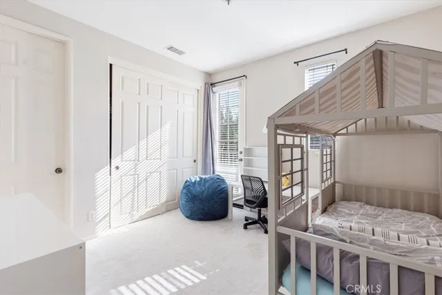 a bedroom with furniture and a window