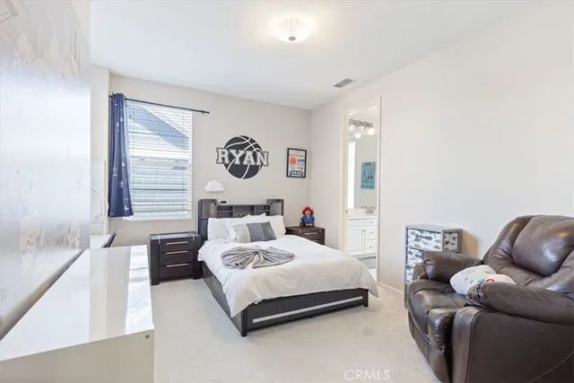 a bedroom with a bed couch and window