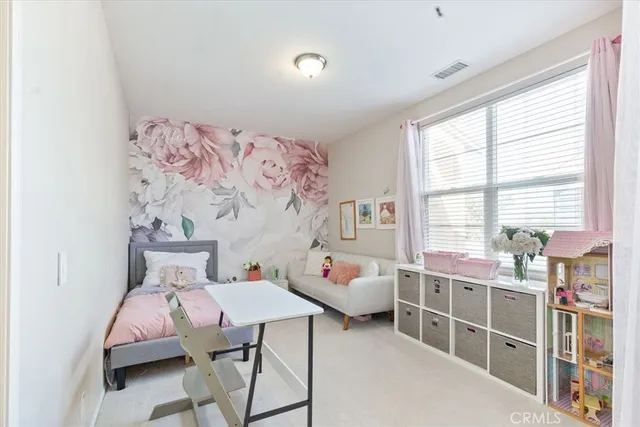 a bed room with a bed and a chair in it