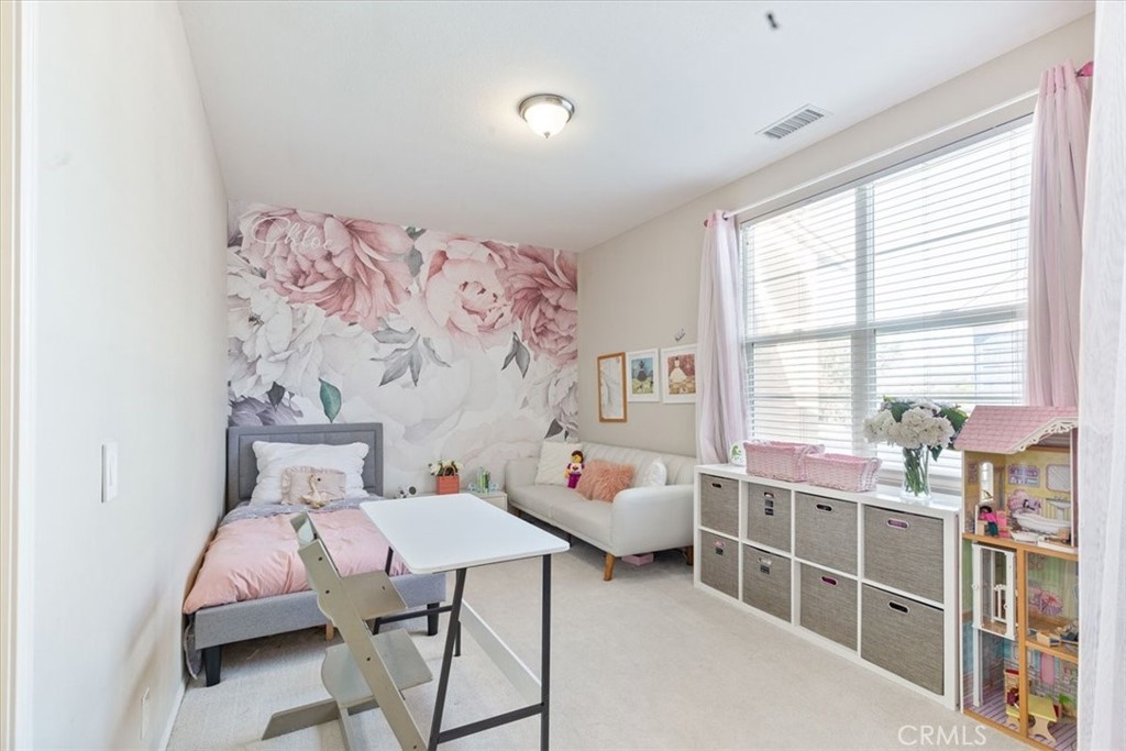 33 Craftsbury Place Ladera Ranch, CA 92694 - Photo 29 of 33 a bed room with a bed and a chair in it