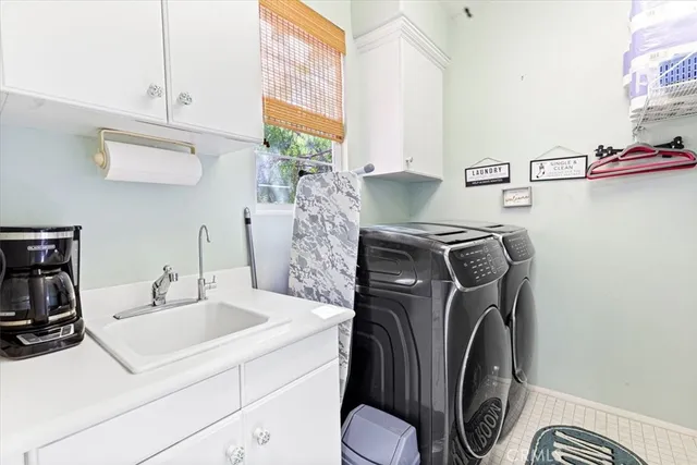 a utility room with sink dryer and washer
