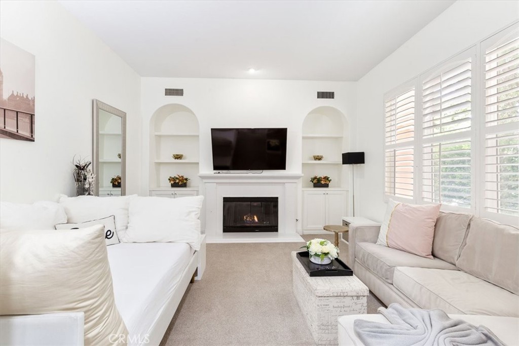 33 Craftsbury Place Ladera Ranch, CA 92694 - Photo 6 of 33 a living room with furniture a fireplace and a flat screen tv