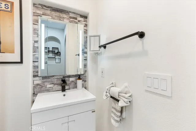 a bathroom with a sink a toilet and mirror