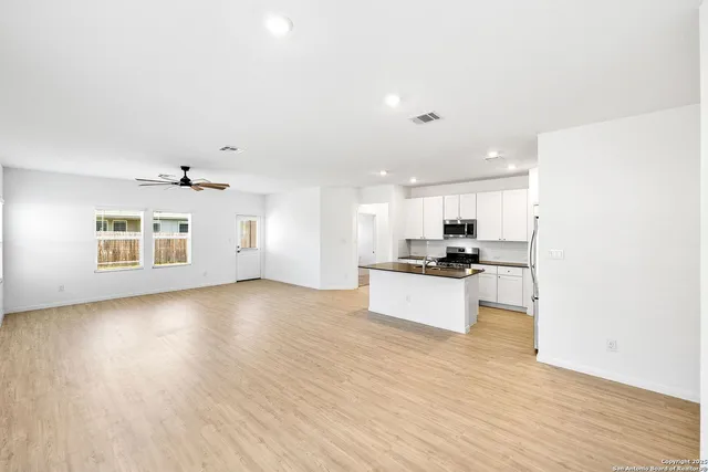 a view of kitchen with sink and wooden floor