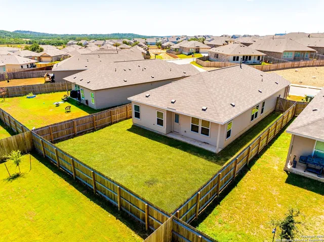 a view of a house with pool and chairs